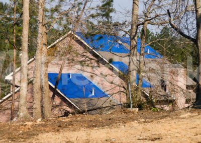 Tornado damaged house with a Flexitank tarpaulin on the roof